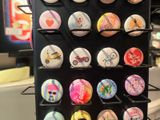 a display of buttons and magnets in a store