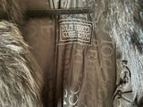 a jacket with a fur collar and a tag on it