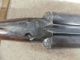 a close up of a gun with a wooden handle