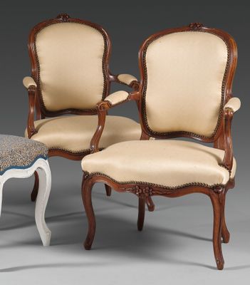 two chairs and a foot stool are sitting next to each other