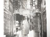 an old photo of a room with a clock on the wall