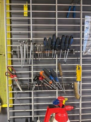 many tools hanging on the wall in the garage