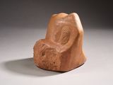 a stone chair that is sitting on a white surface