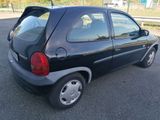 a picture of a small black car parked in a parking lot