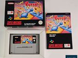 two boxes of nintendo games sitting on top of a white table
