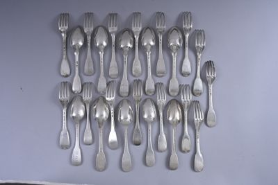 a lot of forks and spoons hanging on the wall