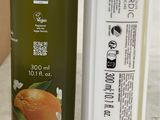 a bottle of olive oil and a tube of lotion on a counter