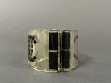 black and gold cuff bracelet with squares and dots