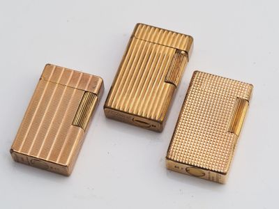 three different types of lighters sitting on a white surface
