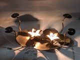 a light that is on in the middle of a flower arrangement