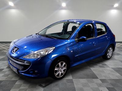 the small blue car is parked in the garage on a checkered floor