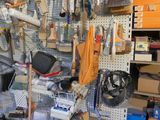 many tools hanging on the wall in this garage