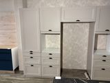 a kitchen with white cabinets and blue drawers in it