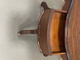 a wooden shelf with a mirror on top of it