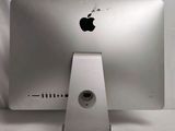 a silver apple computer sitting on top of a white table