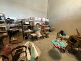 a room with a lot of boxes and chairs in it