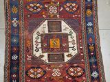 an old rug on the floor with a cross on it