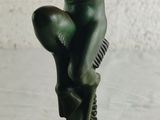 statue of a woman holding a cell phone in her right hand