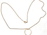 necklace with a gold chain and a pearl pendant on a white background