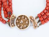 an image of a close up of a necklace on a white surface