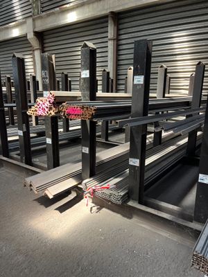 a lot of metal shelves in a warehouse with a bunch of flowers