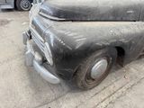 an old car that is sitting on the side of the road