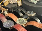 many different types of watches on display in a display case