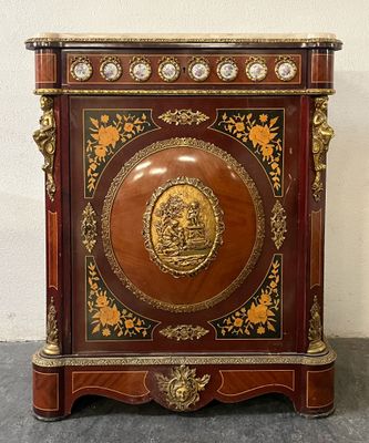 a small wooden cabinet with a gold medallion on it