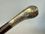 a close up of a cane with a decorative design on it