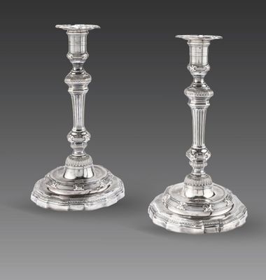a pair of silver candlesticks, by person