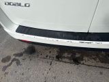 a close up of a white car parked on the side of the road