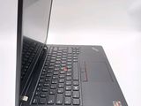 the back of a laptop with a black keyboard on a white surface
