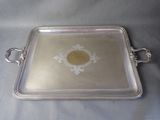 a silver tray that has a flower design on it