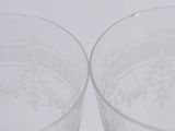 two glasses sitting next to each other on a table