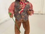 a figurine of a man with a straw hat and a cane
