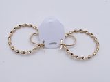 a pair of gold hoop earrings on a white background