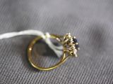 a gold ring with a blue stone on top of it