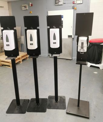 three black and white target stands in the middle of a room
