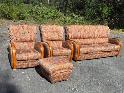 three couches and a chair in a parking lot