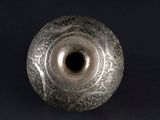 an image of a silver vase on a black background