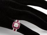 an image of a woman ' s hand with a diamond and ruby ring on it