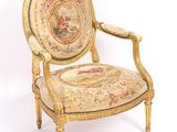 a chair that has a tapestry on the back of it