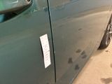 a sticker on the door of a green car