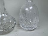 two glass vases sitting next to each other on a table