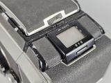 a close up of an old camera with a small screen