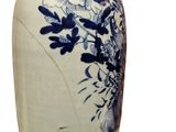 a blue and white vase with flowers on it