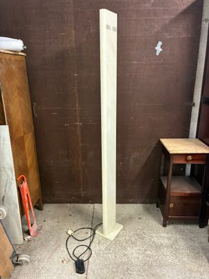 a picture of a floor lamp in a room with a brown wall