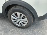 a close up of a car ' s tire on the road