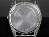 an image of a close up of a watch on a black surface