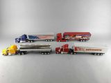five toy trucks that are lined up on a table